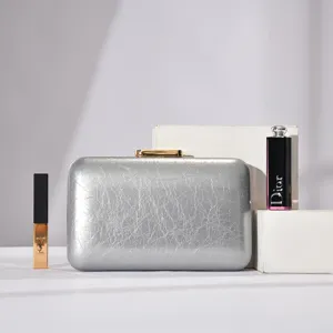 Silver cracked texture evening clutch bag detail view, elegant metal clasp accessory.