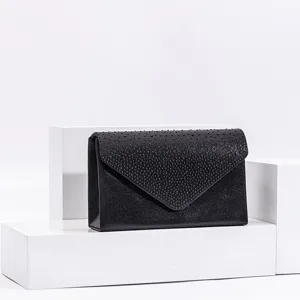 Black sparkle evening clutch bag detail view, elegant envelope design for parties and events.