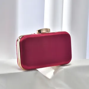 Red satin evening clutch bag with gold hardware detail, perfect for parties and wedding events.