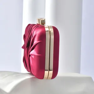 Burgundy pleated satin evening clutch bag with gold metal frame for party and dress.