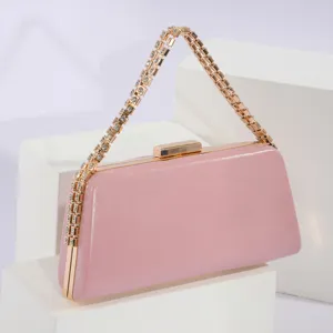 Pink PU leather evening clutch bag with rhinestone chain strap and gold hardware.