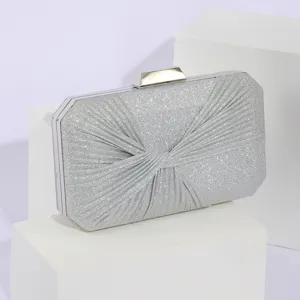 Silver glitter evening clutch bag with pleated design and metallic clasp for party dresses.