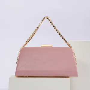 Stunning pink evening clutch bag detail, elegant rhinestone chain strap and gold hardware.