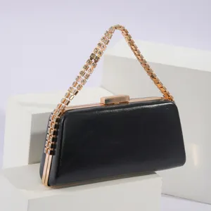 Detail view of elegant black PU leather evening clutch bag featuring stunning rhinestone chain strap.