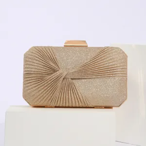 Detail view of the elegant gold glitter pleated evening clutch bag with metallic clasp for events.