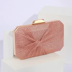 Elegant pink glitter evening clutch bag with metallic frame and unique pleated design for women.