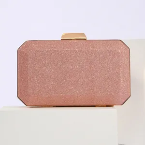 Detailed view of the sparkling glitter evening clutch purse, featuring a sleek gold metal clasp.