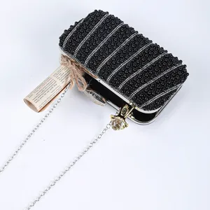 Elegant black beaded evening clutch bag with sparkling rhinestones and metal chain shoulder strap.