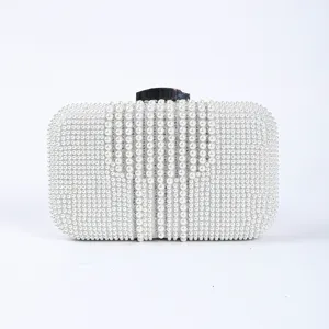 White pearl evening clutch bag with sparkling rhinestones and silver metal clasp for wedding