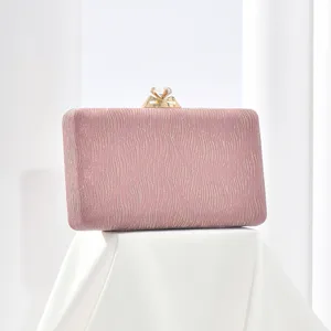 Detailed view of elegant pink glitter evening clutch bag with sparkling crystal clasp decoration