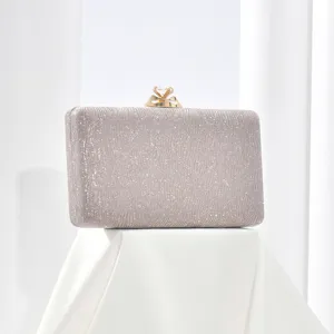 Detailed view of the sparkling silver evening clutch bag with exquisite gold diamond clasp.