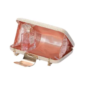 Glitter evening clutch bag with metallic closure, stylish party shoulder handbag for women.
