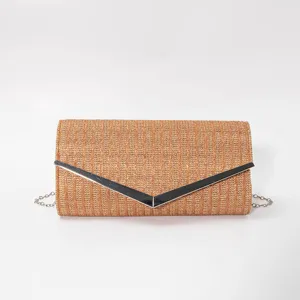 Detailed view of vintage woven envelope evening clutch bag with metallic V clasp and chain strap.