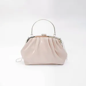 Elegant ruched patent leather clutch handbag with metal handle and detachable chain strap for women.