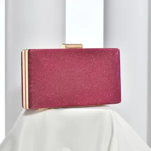 Detailed shot of glittering evening clutch bag with gold-tone clasp, elegant party accessory.