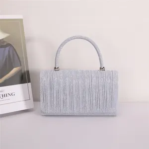 Silver pleated evening handbag, stylish glitter clutch purse with top handle for women detail view.