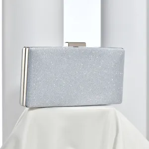 Silver glitter clutch bag with metal clasp, elegant evening party accessory for women.