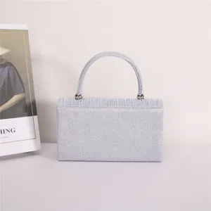 Close-up detail shot of the elegant silver glitter evening handbag showcasing fine texture.