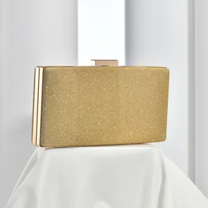 Stunning close-up view of gold glitter evening clutch showcasing exquisite metal frame.