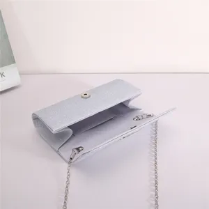 Elegant silver glitter evening clutch bag with metal chain strap and open interior detail view.