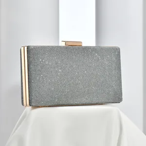 Silver glitter evening clutch bag featuring a gold metal frame, elegant wedding party purse.