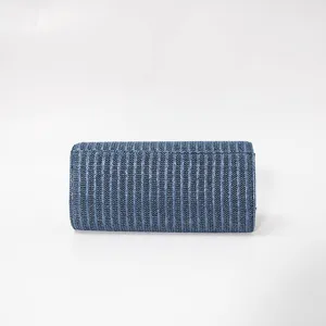 Close-up detail of stylish blue textured evening clutch bag, elegant design, premium PU finish.