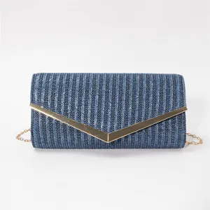 Blue woven texture envelope clutch bag with gold metallic V-clasp and chain strap detail.