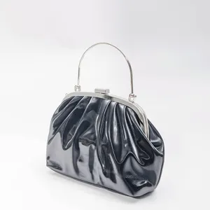 Elegant black patent ruched clutch handbag with silver frame handle for women evening party.