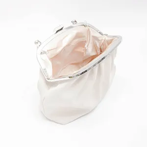Detailed view of the elegant pleated satin cloud evening bag with silver metal clasp frame.