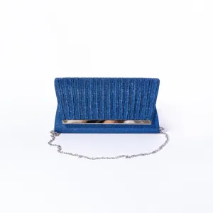 Blue glitter clutch bag detail, evening party bag with metallic bar and silver chain strap.