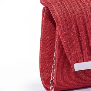Red glitter pleated evening bag detail view, chic metallic party clutch with chain strap.