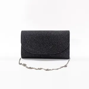 Black glitter evening clutch bag close-up, featuring sparkling sequin texture and chain.