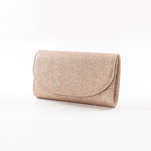 Close-up view of shimmering glitter evening clutch bag detail, sparkling sequin texture.