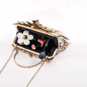 Gold metallic pleated PU clutch bag with metal frame, round handle and chain strap detail.