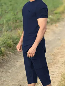 Outdoor detail shot of men's casual short sleeve set in dark blue, breathable fabric.