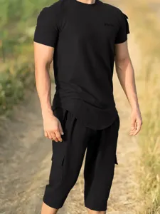 Men's black waffle short sleeve t-shirt and cargo shorts set detail view showcasing fit.