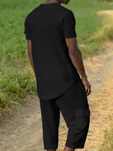 Men's casual black short sleeve waffle knit top and cargo pants stylish streetwear outfit set.