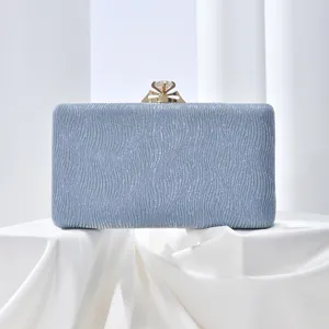 Stunning light blue glitter evening clutch bag with elegant diamond clasp for special events.