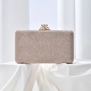 Champagne glitter evening clutch bag with sparkling diamond clasp detail for women parties.