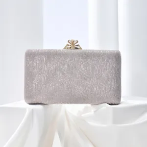 Elegant silver glitter evening clutch bag featuring sparkling diamond clasp for women party.