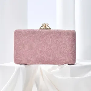 Pink evening clutch bag detailed view showing sparkling texture and diamond clasp design.