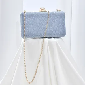 Elegant shimmering evening clutch bag with gold chain and diamond clasp for women parties.