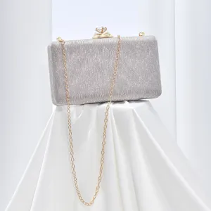 Silver glitter evening clutch bag with elegant gold chain strap and sparkling diamond clasp detail