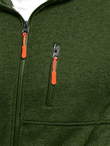 Close-up detail of mens fleece jacket with zip pocket and orange zipper pull. Soft and warm.