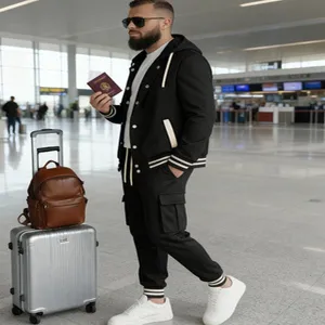 Detailed view of stylish men's casual black hooded tracksuit set in airport travel scene.