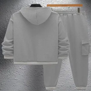 Detailed view of men grey hooded sweatshirt and cargo joggers tracksuit set with striped cuffs.