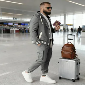 Detail view of mens grey hooded baseball jacket and cargo sweatpants set in airport scene