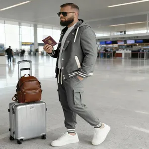 Detail shot of men's casual tracksuit set in airport scene, featuring grey hooded jacket and cargo pants.