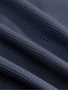 Gros plan sur le tissu de chemise à manches longues jacquard gris foncé et texturé.
