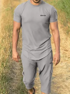 Detailed view of men's casual grey short sleeve t-shirt and cargo shorts outfit.